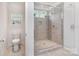 Elegant bathroom showcasing a glass-enclosed shower with gray tile and a built-in bench at 482 Lucky Nw Dr, Concord, NC 28027