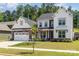 Charming two-story home with a stone-accented garage, front lawn, and professionally landscaped yard at 482 Lucky Nw Dr, Concord, NC 28027