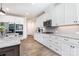 Bright, open kitchen with white cabinets, granite countertops and stainless steel appliances at 482 Lucky Nw Dr, Concord, NC 28027