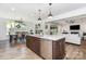 Open-concept kitchen with a large island, granite countertops, stainless steel appliances, and hardwood floors at 482 Lucky Nw Dr, Concord, NC 28027