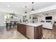 Open-concept kitchen with a large island, granite countertops, stainless steel appliances, and hardwood floors at 482 Lucky Nw Dr, Concord, NC 28027