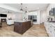 Bright kitchen with white cabinets, stainless steel appliances, a center island, and hardwood floors at 482 Lucky Nw Dr, Concord, NC 28027