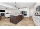 Bright kitchen with white cabinets, stainless steel appliances, a center island, and hardwood floors at 482 Lucky Nw Dr, Concord, NC 28027