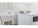 Well-lit laundry room equipped with a utility sink, washer, and dryer at 482 Lucky Nw Dr, Concord, NC 28027