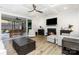 Modern living room featuring a fireplace, coffered ceiling, hardwood floors and a screened-in patio at 482 Lucky Nw Dr, Concord, NC 28027