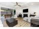 Modern living room featuring a fireplace, coffered ceiling, hardwood floors and a screened-in patio at 482 Lucky Nw Dr, Concord, NC 28027
