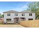 Backyard view of home featuring screened in porch and privacy fence at 514 W Cama St, Charlotte, NC 28217