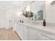 Bright bathroom with double vanity, white countertops, modern fixtures, and wood floors at 514 W Cama St, Charlotte, NC 28217