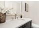 Charming powder room features a modern vanity with stone counters and bronze colored faucet at 514 W Cama St, Charlotte, NC 28217