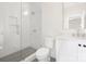 Well lit bathroom with ceramic tile shower and white vanity at 514 W Cama St, Charlotte, NC 28217