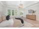 Serene main bedroom with tray ceiling, large windows, stylish furnishings, and ample natural light at 514 W Cama St, Charlotte, NC 28217