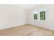 Sunlit bedroom with hardwood floors, large windows offering pleasant views and white walls at 514 W Cama St, Charlotte, NC 28217