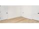 Spacious bedroom with white doors, fresh paint, light hardwood floors and natural light at 514 W Cama St, Charlotte, NC 28217