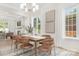 Inviting dining room with stylish chandelier, natural light, and an elegant wood table and chairs at 514 W Cama St, Charlotte, NC 28217