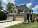 Stunning two-story home featuring a brick and siding exterior, two-car garage, and well-manicured landscaping at 514 W Cama St, Charlotte, NC 28217
