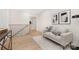 Cozy hallway with a comfortable seating area, modern art, and hardwood flooring at 514 W Cama St, Charlotte, NC 28217