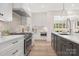 Modern kitchen featuring stainless steel appliances, custom cabinetry, quartz countertops, and ample lighting at 514 W Cama St, Charlotte, NC 28217