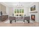 Well-lit living room featuring modern furnishings, large windows, and a cozy fireplace at 514 W Cama St, Charlotte, NC 28217
