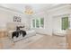 Bright main bedroom featuring a plush bed, large windows, and stylish decor and a light wood floor at 514 W Cama St, Charlotte, NC 28217