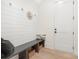 Mudroom features shiplap accent wall, storage bench, and wood look floors at 514 W Cama St, Charlotte, NC 28217