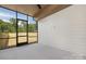 Sunroom features shiplap accent wall, gray flooring, and great natural light at 514 W Cama St, Charlotte, NC 28217