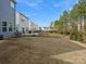 Large backyard with a black fence and minimal landscaping, offering potential for customization at 518 Palmarosa St, Fort Mill, SC 29715