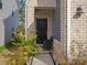Inviting entryway with a black front door, brick and siding, and a charming walkway with plantings at 518 Palmarosa St, Fort Mill, SC 29715