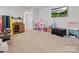Spacious playroom with plush carpeting, a television, and plenty of room for activities at 518 Palmarosa St, Fort Mill, SC 29715