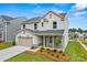Charming two-story home featuring stone accents, attached garage, and landscaped front yard at 5236 Hatcher Creek Rd # 52, Charlotte, NC 28215