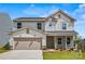 Charming two-story home featuring stone accents, attached garage, and landscaped front yard at 5236 Hatcher Creek Rd # 52, Charlotte, NC 28215