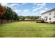 Spacious backyard with a lush lawn, mature trees, and privacy fence, ideal for Gathering gatherings at 600 Capella Ct, Gastonia, NC 28056