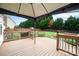 Backyard deck featuring wood-decking, black metal railing, and mature trees at 600 Capella Ct, Gastonia, NC 28056