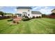 Spacious backyard featuring a well-maintained lawn, patio deck, privacy fence, and attractive landscaping at 600 Capella Ct, Gastonia, NC 28056