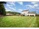 Expansive backyard view featuring mature trees, fencing, deck and patio at 600 Capella Ct, Gastonia, NC 28056