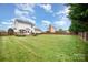 Expansive green backyard featuring a deck, privacy fence, mature trees and landscape accents at 600 Capella Ct, Gastonia, NC 28056
