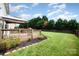 A backyard deck and a fenced in lawn that features green grass, a gazebo and tasteful landscaping at 600 Capella Ct, Gastonia, NC 28056