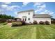 Exterior view of a well-maintained two-story home with lush backyard and patio at 600 Capella Ct, Gastonia, NC 28056