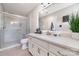 Bathroom featuring modern vanity, quartz countertop, and glass-enclosed walk-in shower at 600 Capella Ct, Gastonia, NC 28056