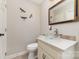 Half bathroom featuring a glass bowl sink, decorative dragonflies and a gold trimmed mirror at 600 Capella Ct, Gastonia, NC 28056