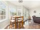 Bright breakfast nook features hardwood floors, a wooden table, and large windows overlooking the outdoors at 600 Capella Ct, Gastonia, NC 28056