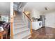 Open entryway with hardwood floors, stairs, and adjacent kitchen area at 600 Capella Ct, Gastonia, NC 28056