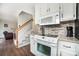 Well-appointed kitchen featuring stainless appliances, light cabinets, mosaic backsplash, and wooden floors at 600 Capella Ct, Gastonia, NC 28056