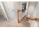 Carpeted staircase with white railing leads to dining area with natural light in well-maintained home at 600 Capella Ct, Gastonia, NC 28056