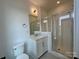 Bright bathroom featuring a glass-enclosed shower and a modern vanity with marble countertop at 6013 Countess Dr # 51, Charlotte, NC 28217