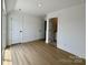 A well-lit bedroom shows doors to the bathroom and hallway, and hardwood flooring at 6013 Countess Dr # 51, Charlotte, NC 28217