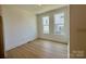 Well-lit dining room featuring hardwood floors, neutral paint color, and large windows at 6013 Countess Dr # 51, Charlotte, NC 28217