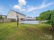 Large backyard with hammock, shade tree, and white privacy fence at 6017 Fazio Ct, Harrisburg, NC 28075