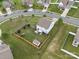 An aerial view of a backyard featuring a well-maintained lawn, wooden fence, and storage shed at 6017 Fazio Ct, Harrisburg, NC 28075