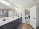 Spacious bathroom with double vanity, walk-in shower, and an open view to the bedroom at 6017 Fazio Ct, Harrisburg, NC 28075