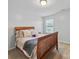 Cozy bedroom featuring a wooden-framed bed with plush pillows and a gray throw blanket at 6017 Fazio Ct, Harrisburg, NC 28075